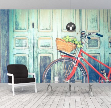 Bild på Hipster red bicycle in old building walls background  color if vintage tone 